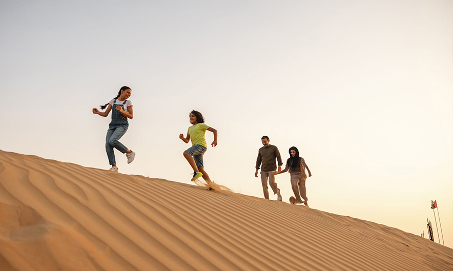 Sandboarding and dunes during morning safari in Dubai